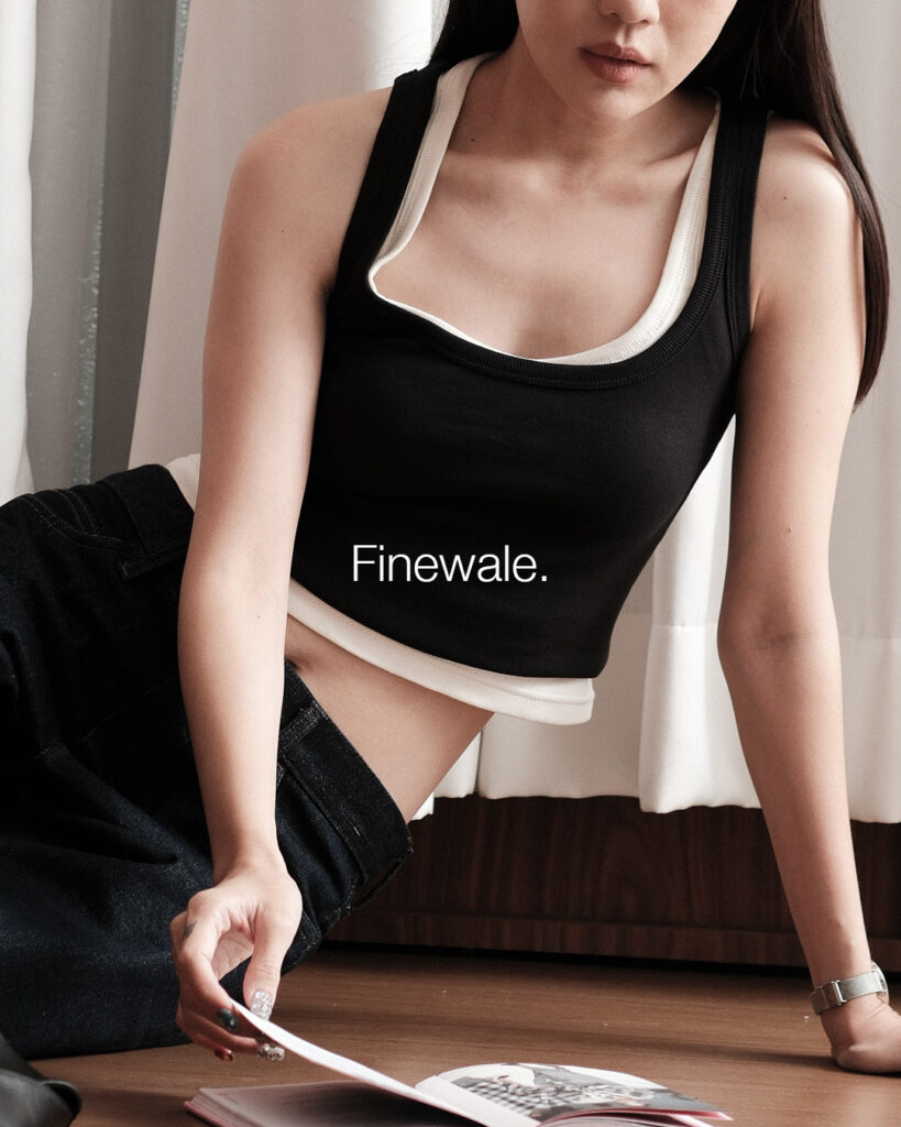 Woman in a black Scoopneck Tank layered over Cloud Dancer