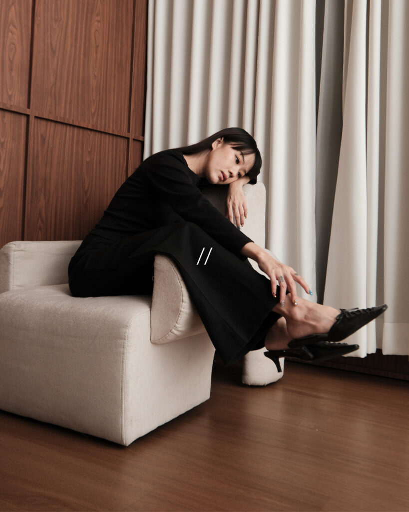 Woman in black Finewale pieces seated in an armchair