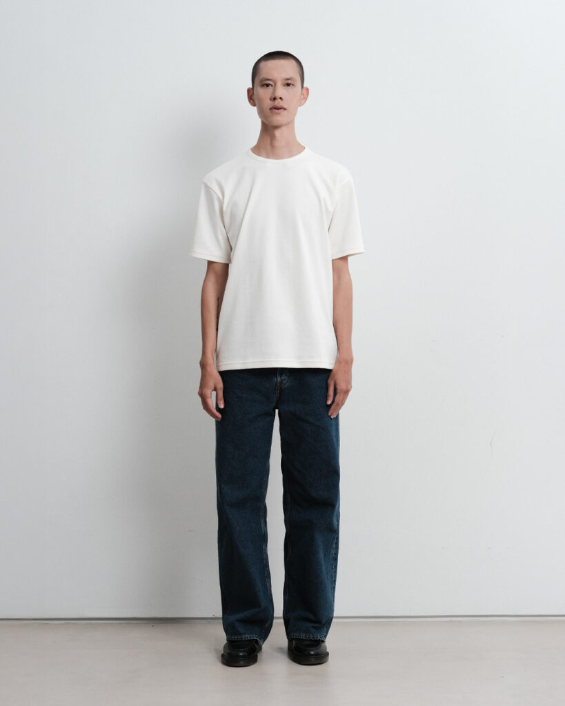 Man wearing the Regular T-shirt in Cloud Dancer with jeans